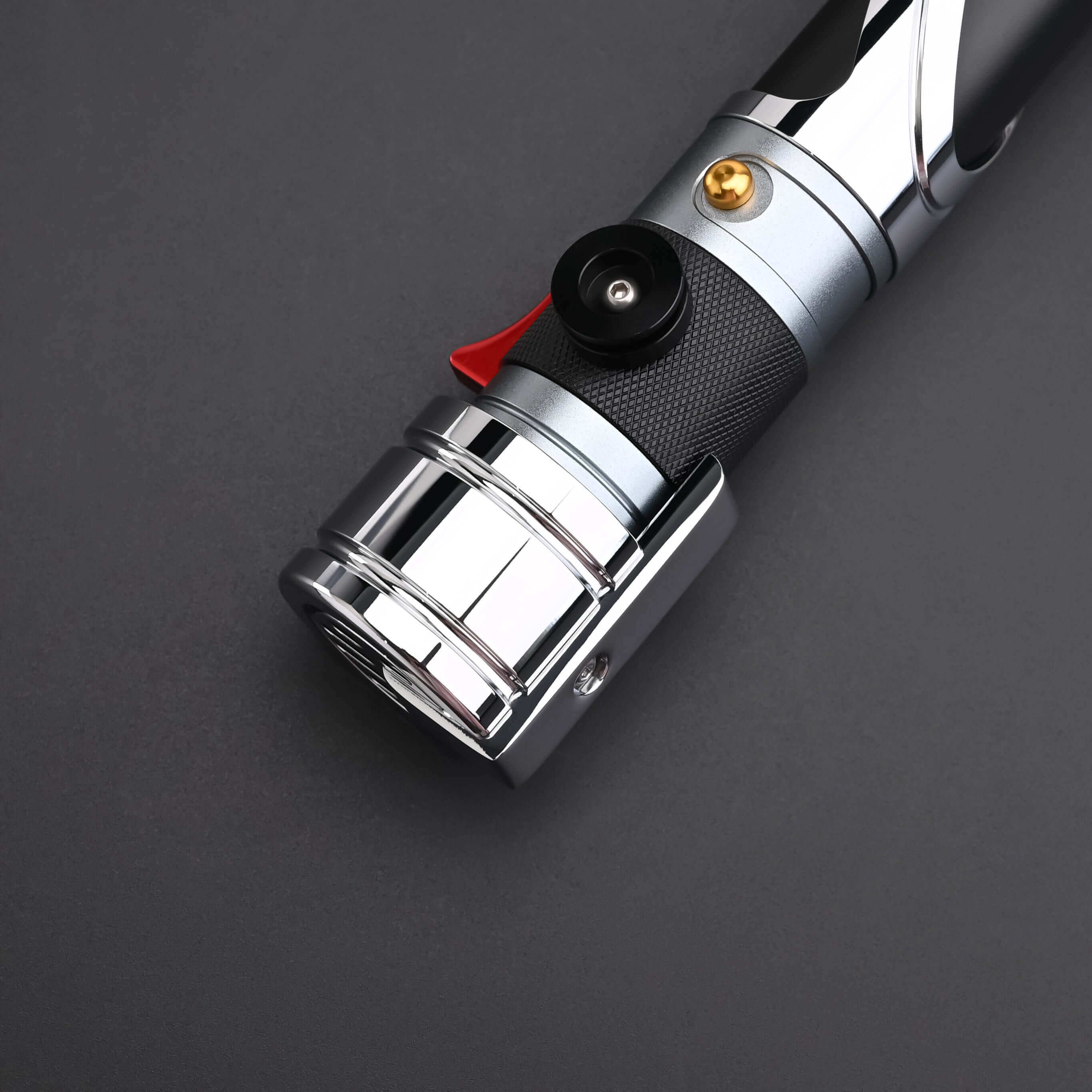 Count SE Lightsaber with black and silver hilt, spiraling silver trim, gold and red accents, and flared emitter. Crafted from aircraft-grade aluminum for balance, control, and precision.