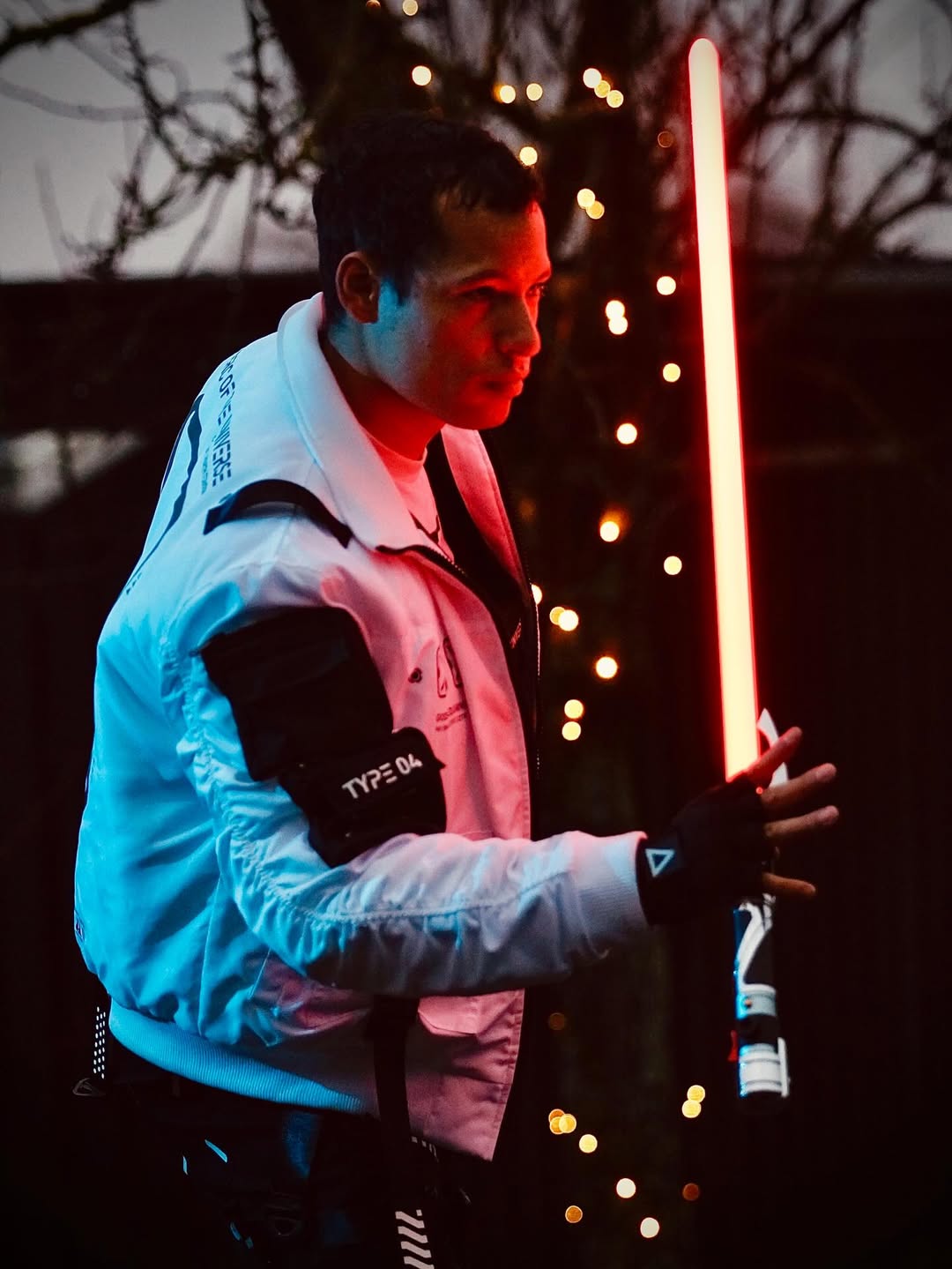 Count SE Lightsaber with black and silver hilt, spiraling silver trim, gold and red accents, and flared emitter. Crafted from aircraft-grade aluminum for balance, control, and precision.