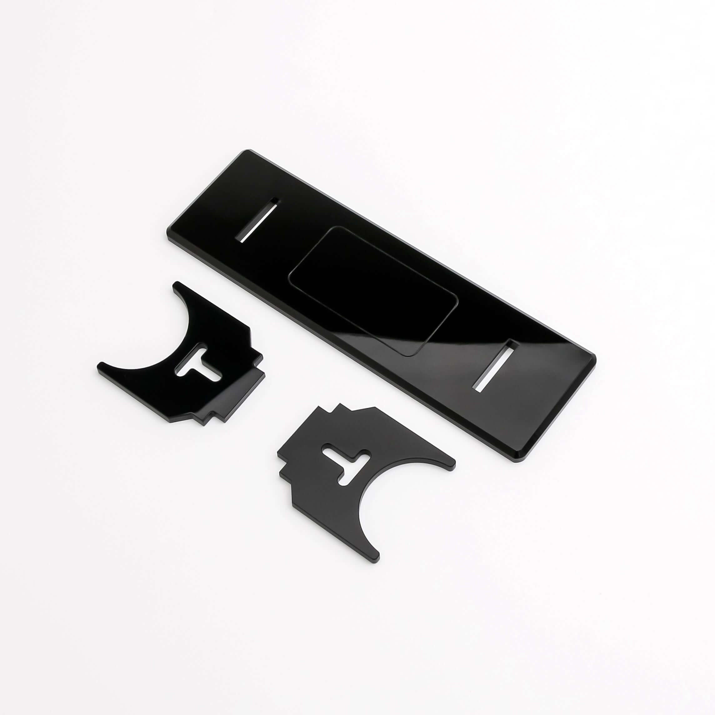 Black acrylic display stand components for showcasing collectibles with stability and visual appeal.