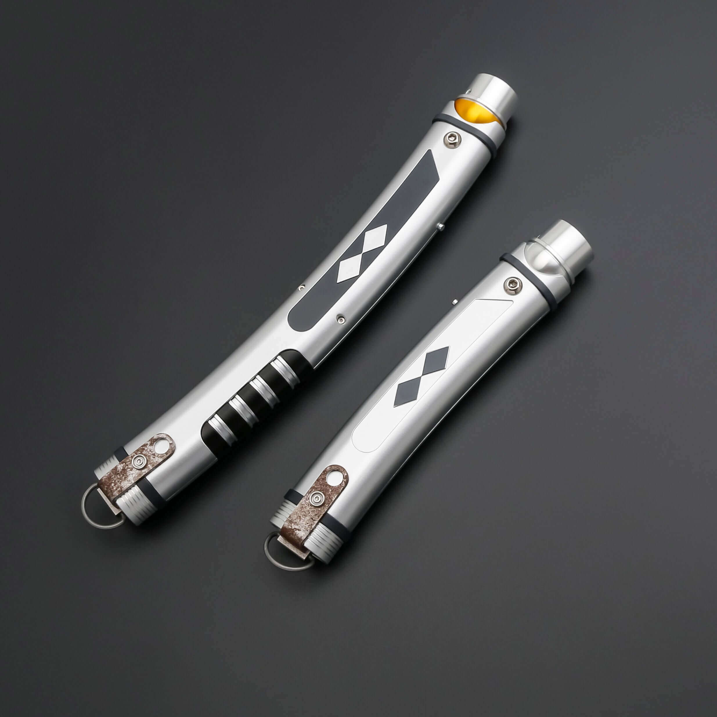 Tano lightsaber with silver and black anodized aluminum hilt, featuring 12 blade colors, 27 sound fonts, and options for Baselit, S-RGB, Neopixel, or Proffie cores, ideal for cosplay and light dueling.