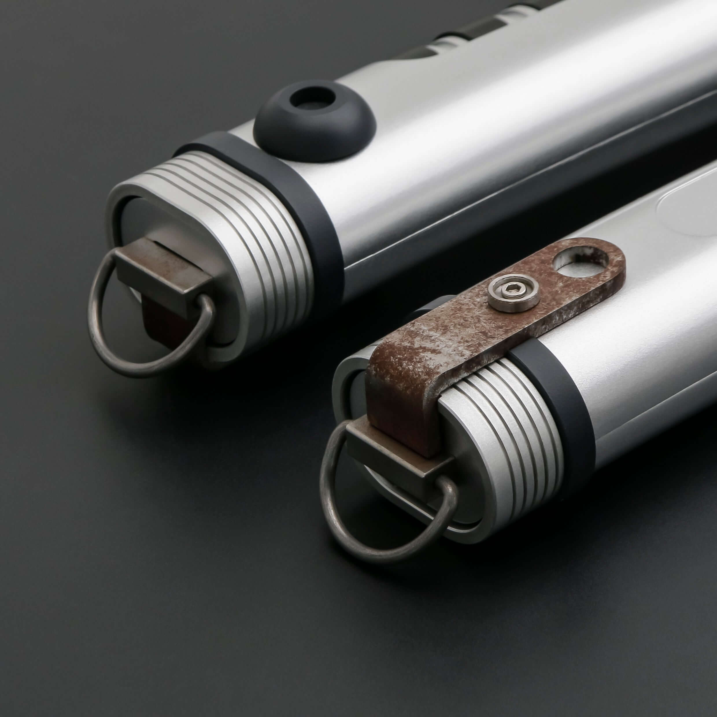 Tano lightsaber with silver and black anodized aluminum hilt, featuring 12 blade colors, 27 sound fonts, and options for Baselit, S-RGB, Neopixel, or Proffie cores, ideal for cosplay and light dueling.