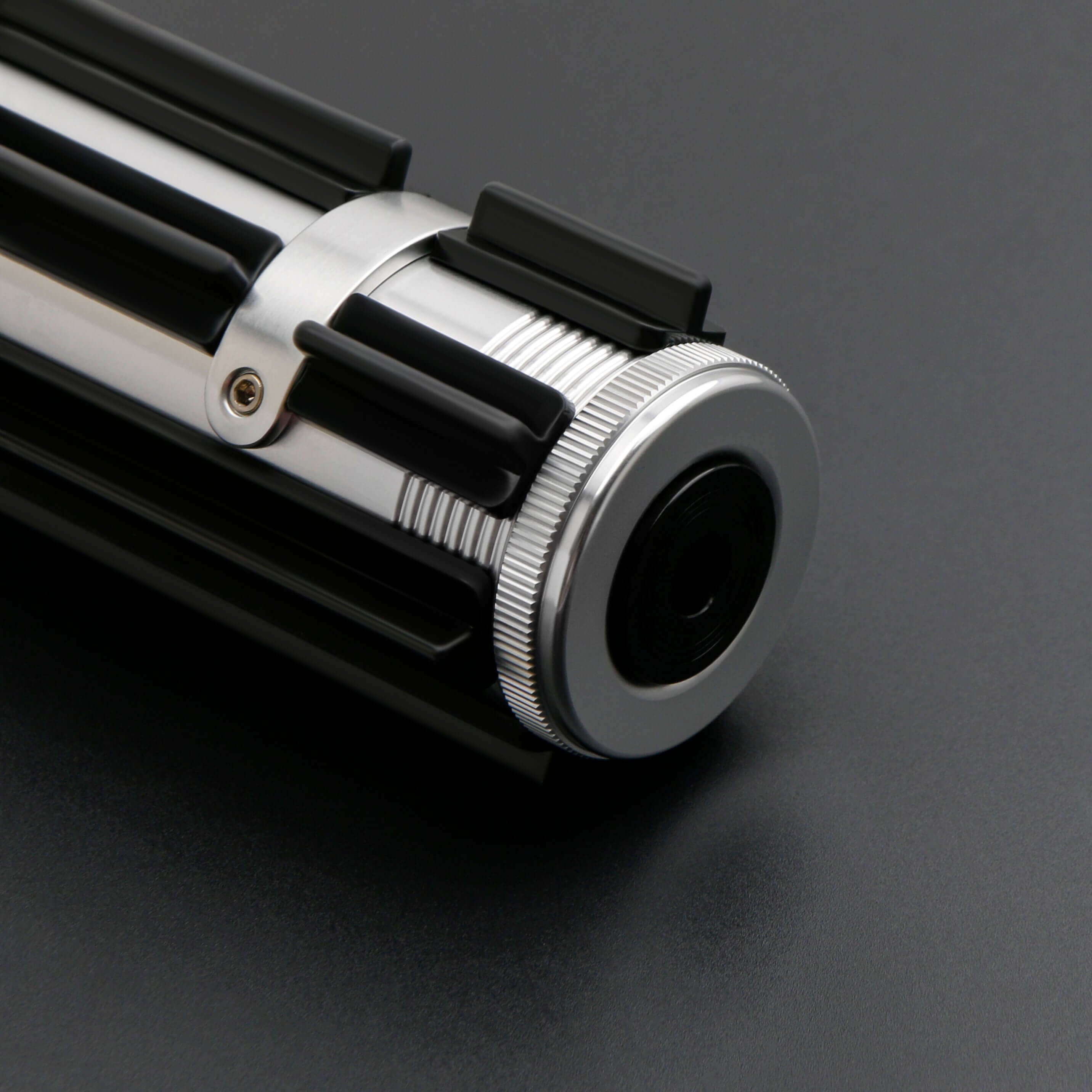 Elzar Mann lightsaber with black anodized aluminum hilt, polished silver accents, 32" polycarbonate blade, 27 sound fonts, 12 blade colors, and Neopixel or Proffie core options for dynamic effects and dueling.