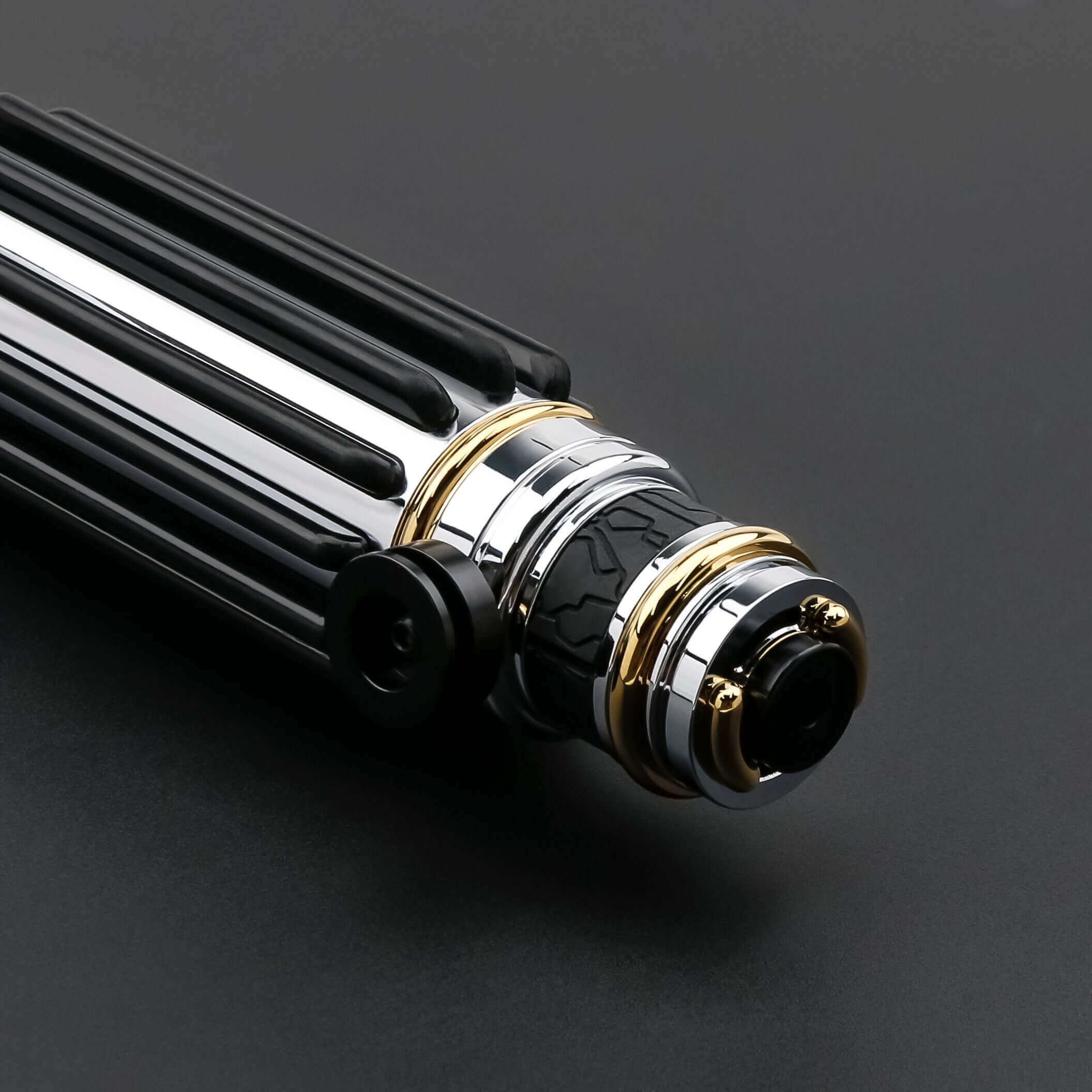 Windu Proffie lightsaber close-up view showing its sleek design and metallic finish.