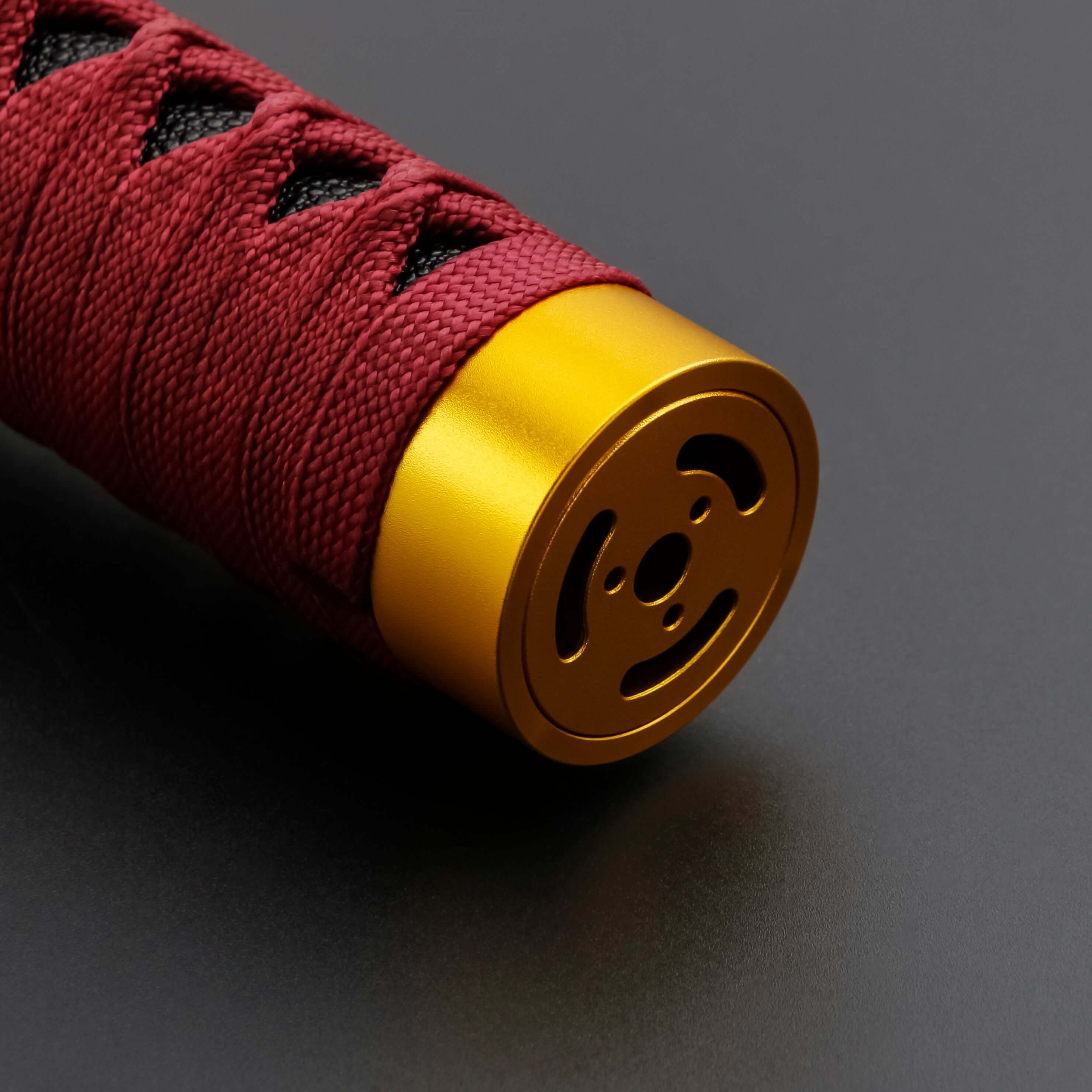 Sekiro Lightsaber: Katana-inspired design with gold hilt, red grip, and gold guard, crafted from aircraft-grade aluminum for durability and elegance.