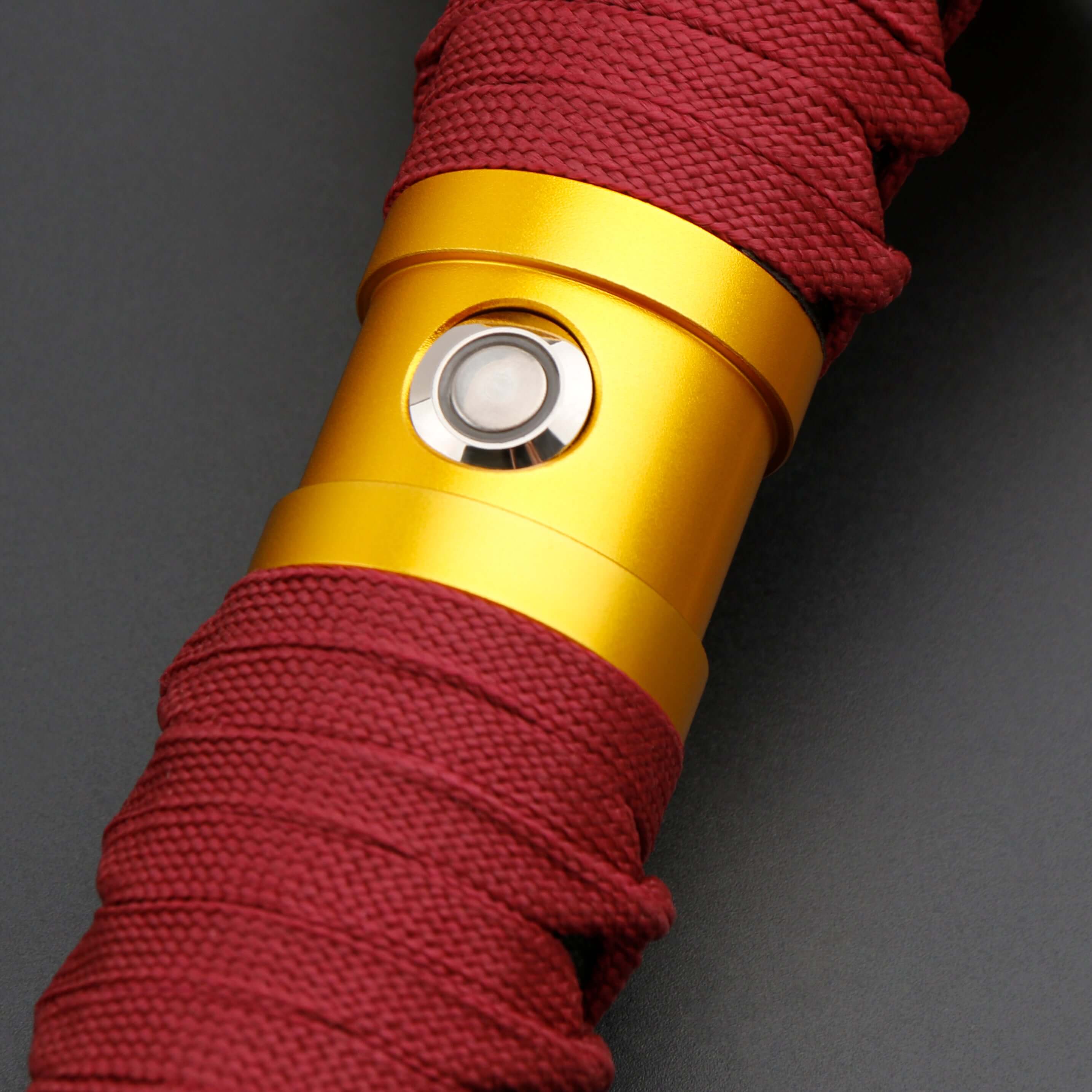 Sekiro Lightsaber: Katana-inspired design with gold hilt, red grip, and gold guard, crafted from aircraft-grade aluminum for durability and elegance.