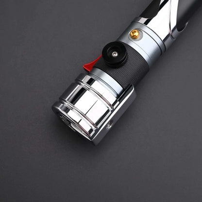 Count SE Lightsaber with black and silver hilt, spiraling silver trim, gold and red accents, and flared emitter. Crafted from aircraft-grade aluminum for balance, control, and precision.
