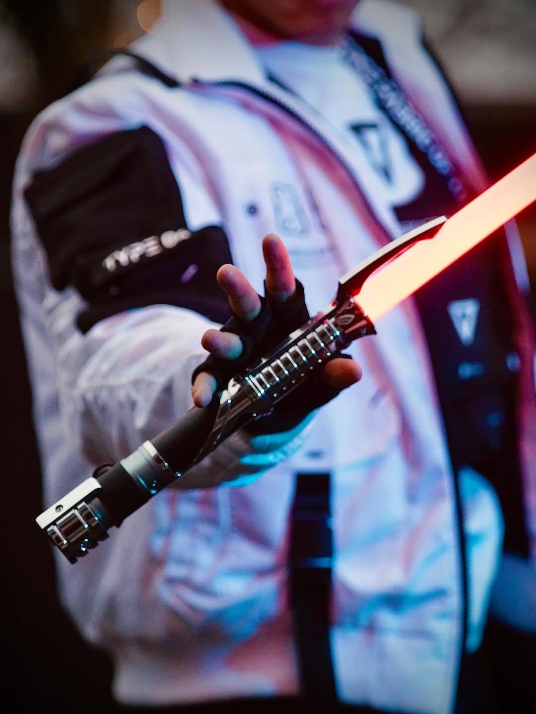 Count SE Lightsaber with black and silver hilt, spiraling silver trim, gold and red accents, and flared emitter. Crafted from aircraft-grade aluminum for balance, control, and precision.