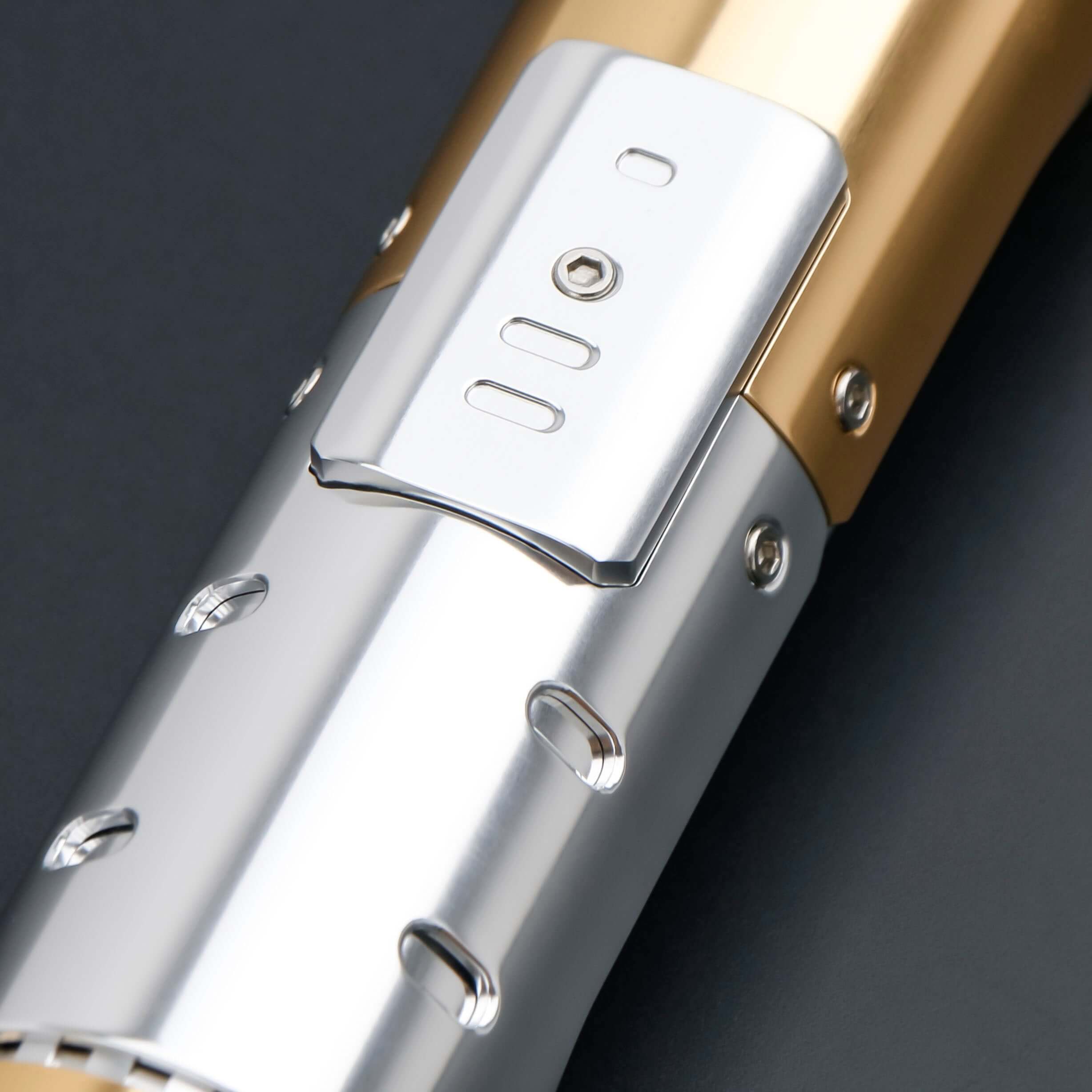 Skeleton Crew SE lightsaber with silver and gold hilt, featuring Baselit, S-RGB, Neopixel, or Proffie core options, 12 blade colors, multiple blade effects, and a durable design suitable for display and light dueling.