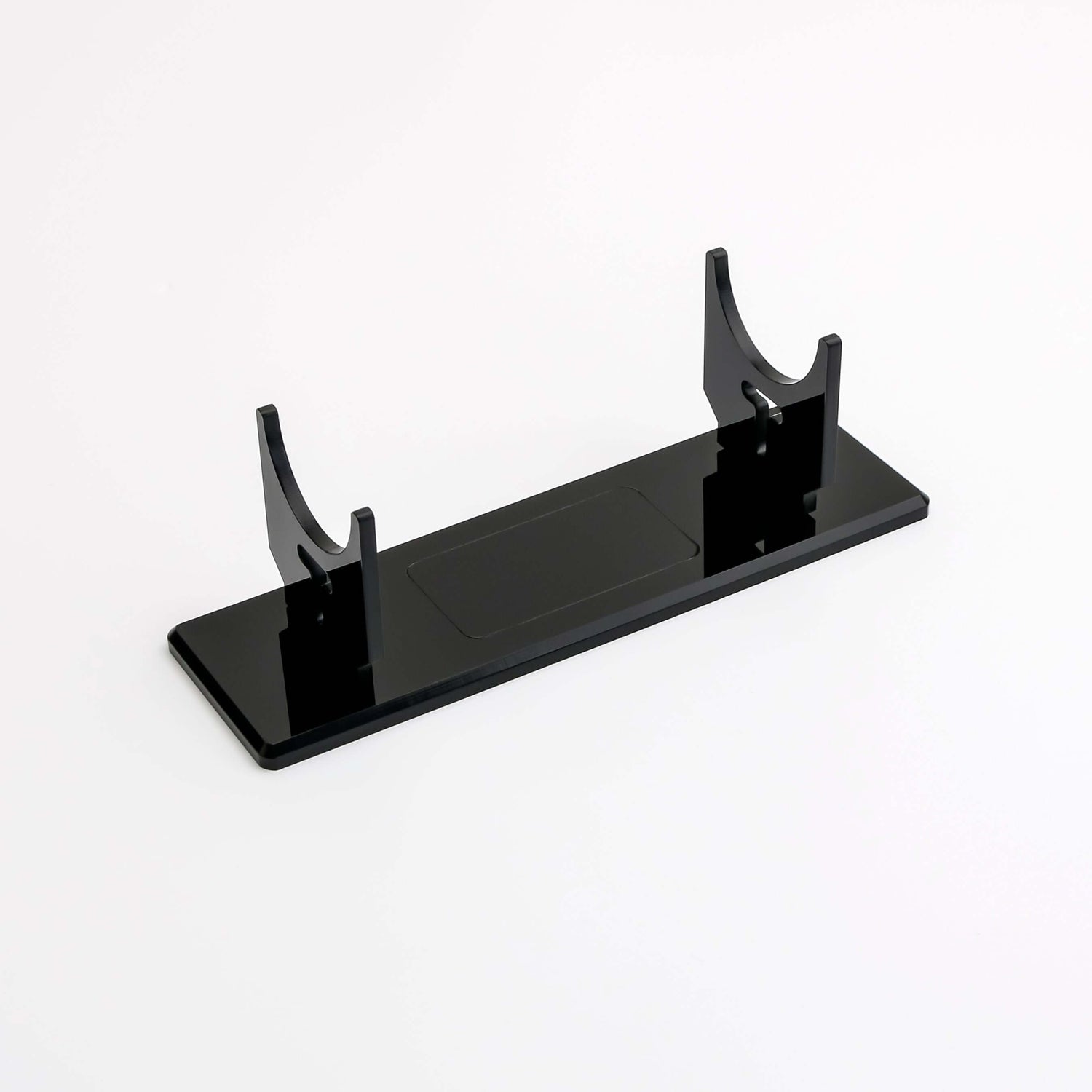 Clear acrylic display stand for showcasing collectibles with stability and style.