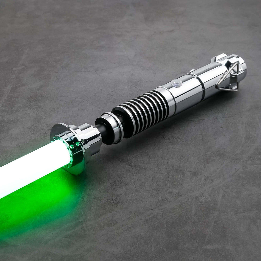 Luke SE Lightsaber from Novasaber, featuring a polished silver hilt with detailed gold accents and a vibrant green blade, inspired by the iconic weapon of Luke Skywalker from Star Wars