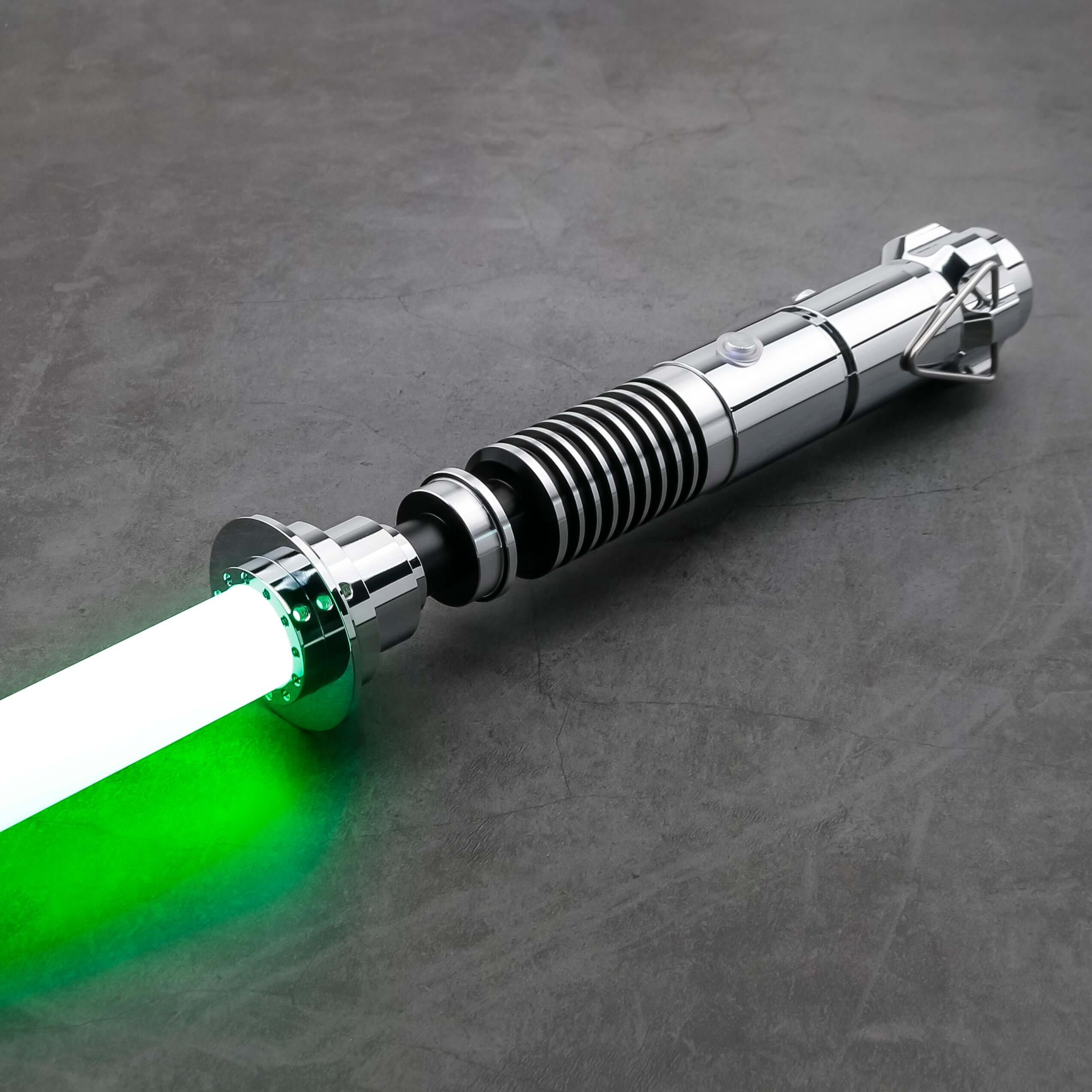 Luke SE Lightsaber from Novasaber, featuring a polished silver hilt with detailed gold accents and a vibrant green blade, inspired by the iconic weapon of Luke Skywalker from Star Wars