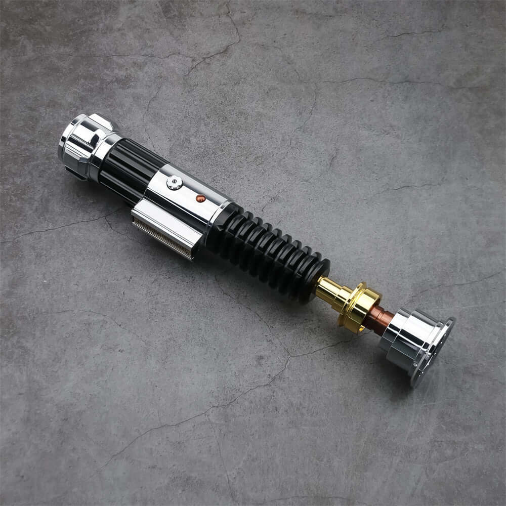 Obi EP3 lightsaber replica resting on a gray surface, showcasing its detailed design and craftsmanship.