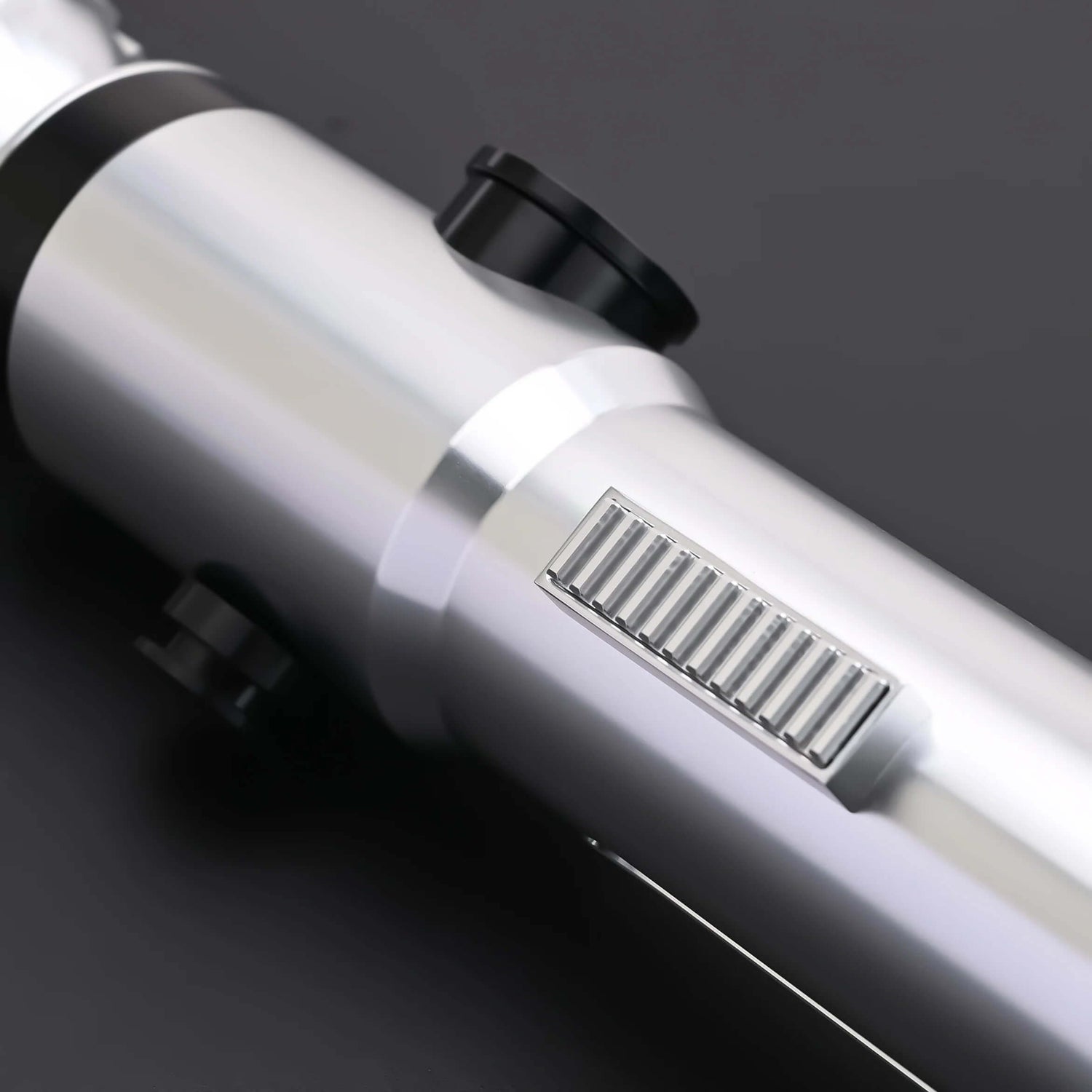 Close-up of the hilt of the Ahsoka Tano CW lightsaber replica showcasing its sleek silver finish and detailed grip.