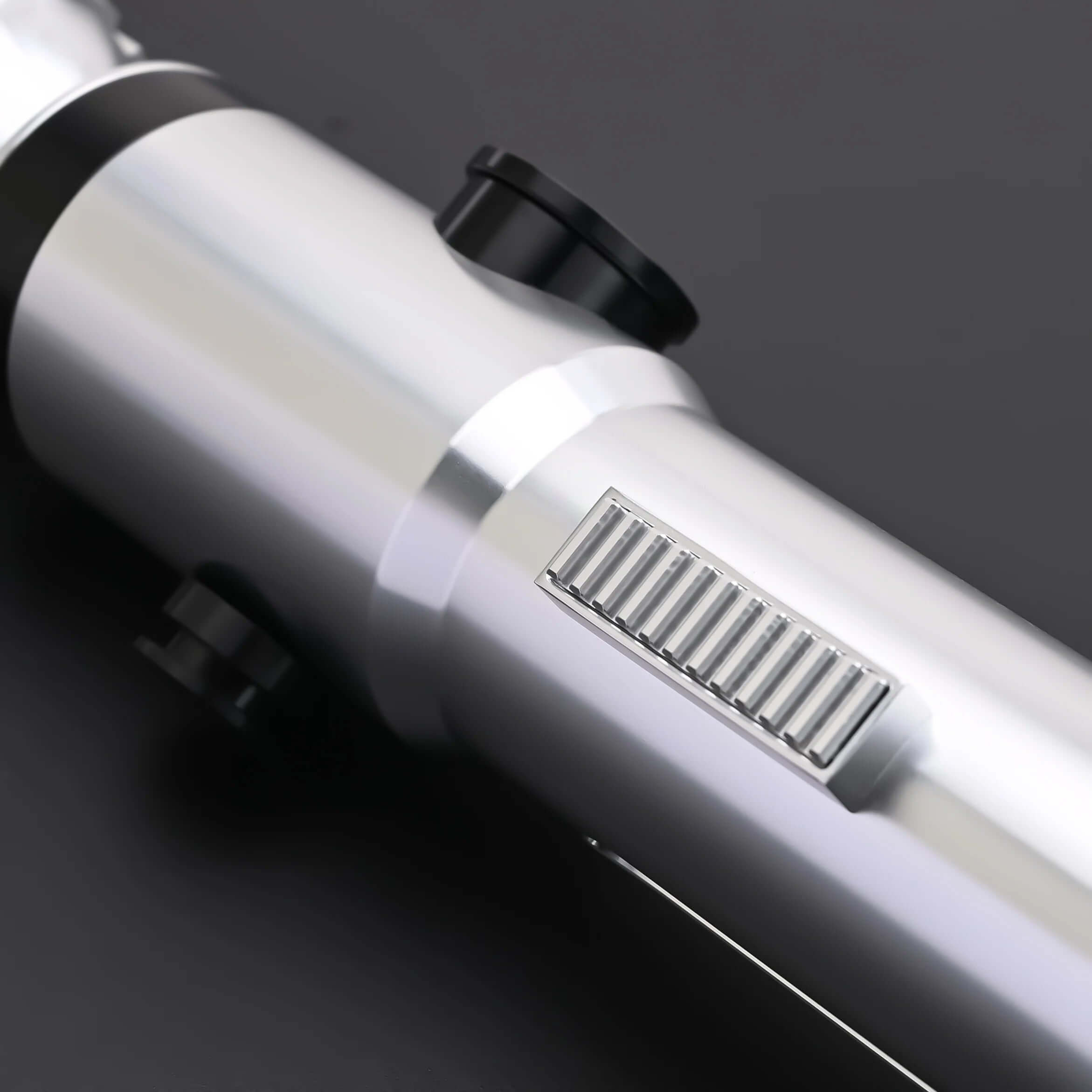 Close-up of the hilt of the Ahsoka Tano CW lightsaber replica showcasing its sleek silver finish and detailed grip.