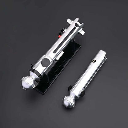Ahsoka Tano CW lightsaber replica displayed on a black base, showcasing its sleek silver design and minimalist hilt.