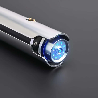 Close-up of the Ahsoka Tano CW lightsaber replica showing the sleek silver hilt and blue emitter lights.