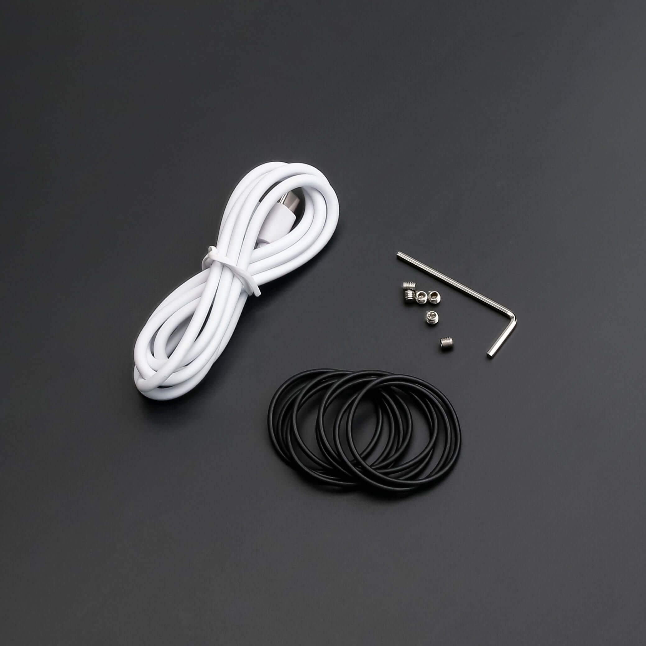 Essential tools for lightsaber maintenance kit including wires, screws, and rubber o-rings.
