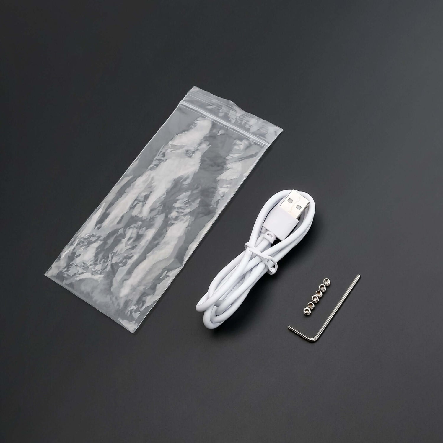 USB charging cable, maintenance tools, and components from the lightsaber maintenance kit.