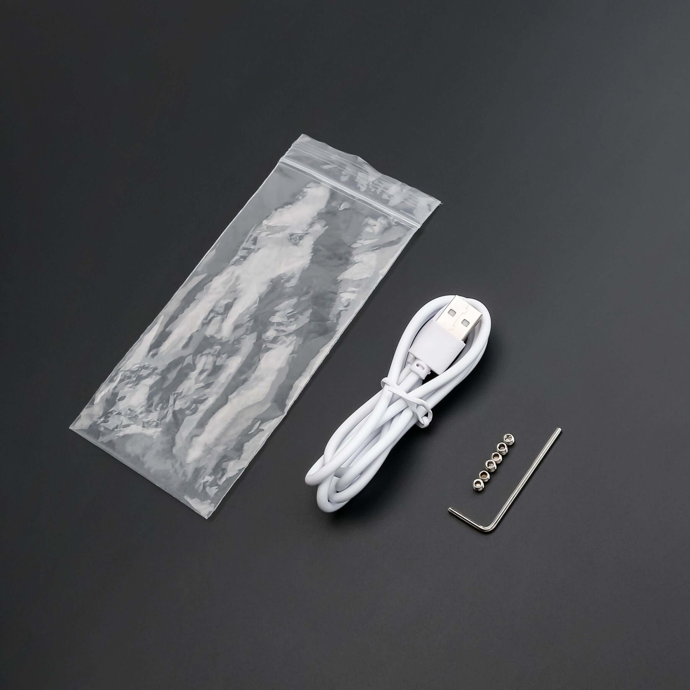 USB charging cable, maintenance tools, and components from the lightsaber maintenance kit.