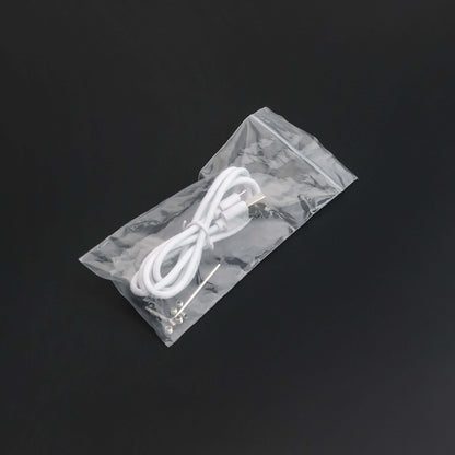 White charging cable for lightsaber maintenance kit in a plastic package.