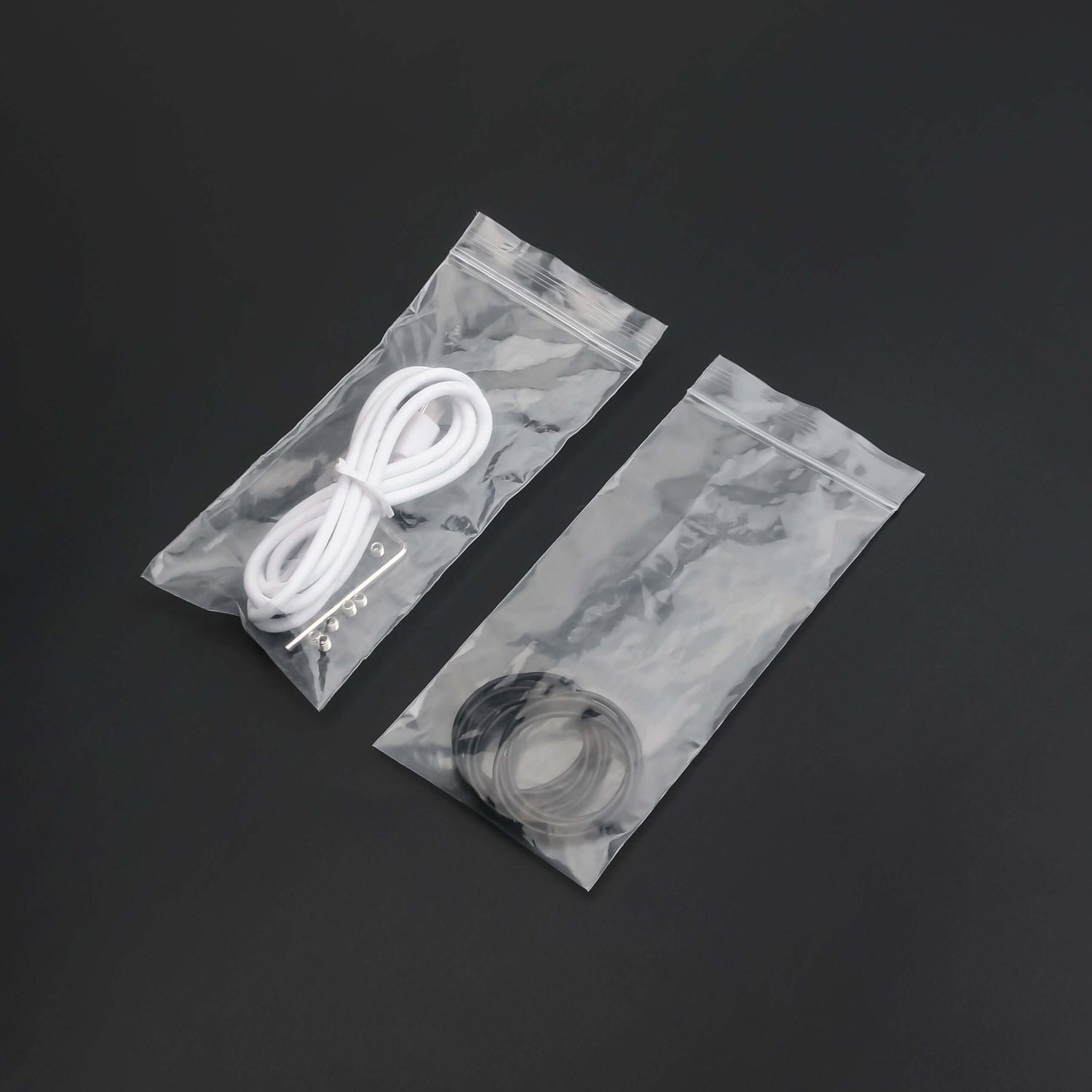 Clear bags containing cords and rings for lightsaber maintenance kit essentials.