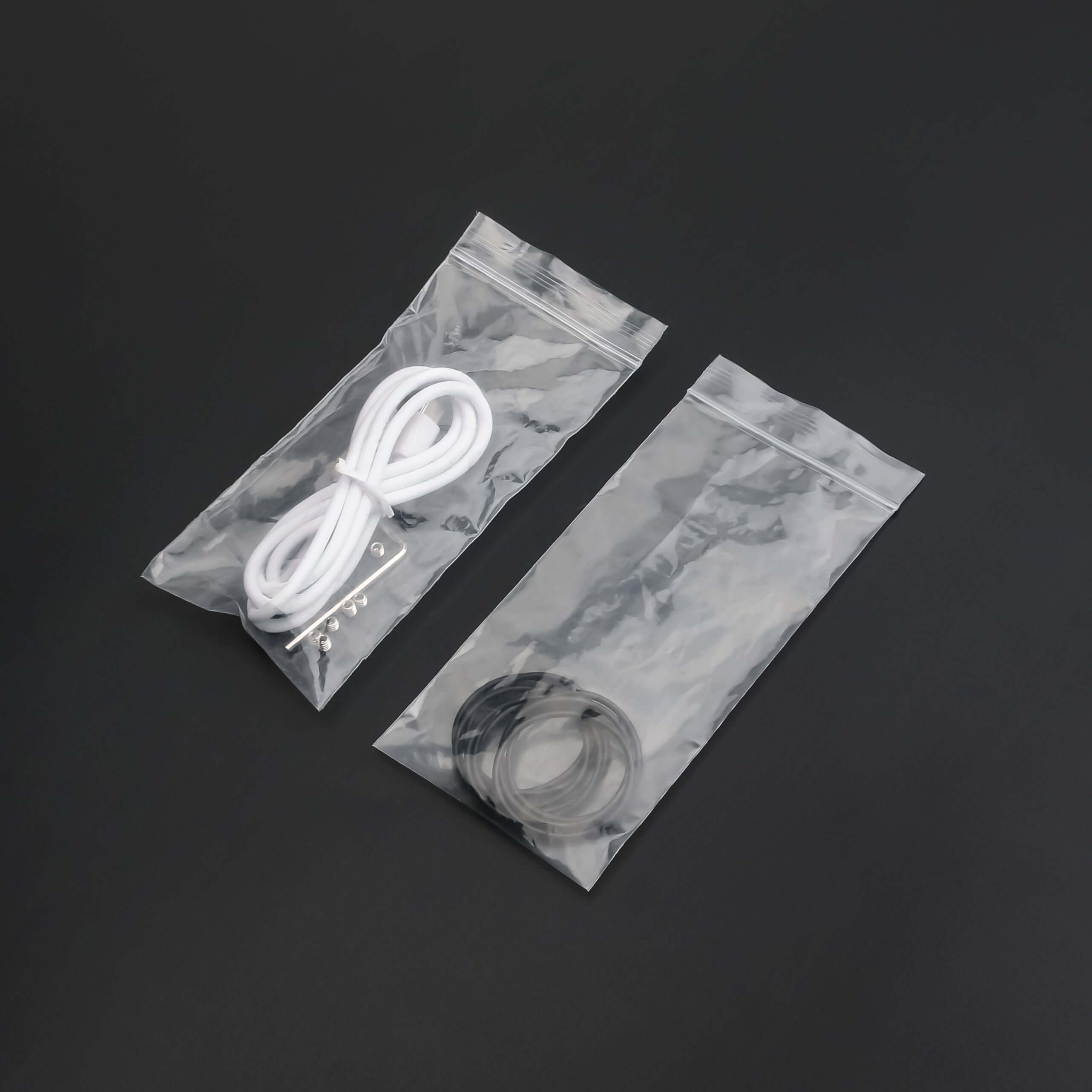 Clear bags containing cords and rings for lightsaber maintenance kit essentials.