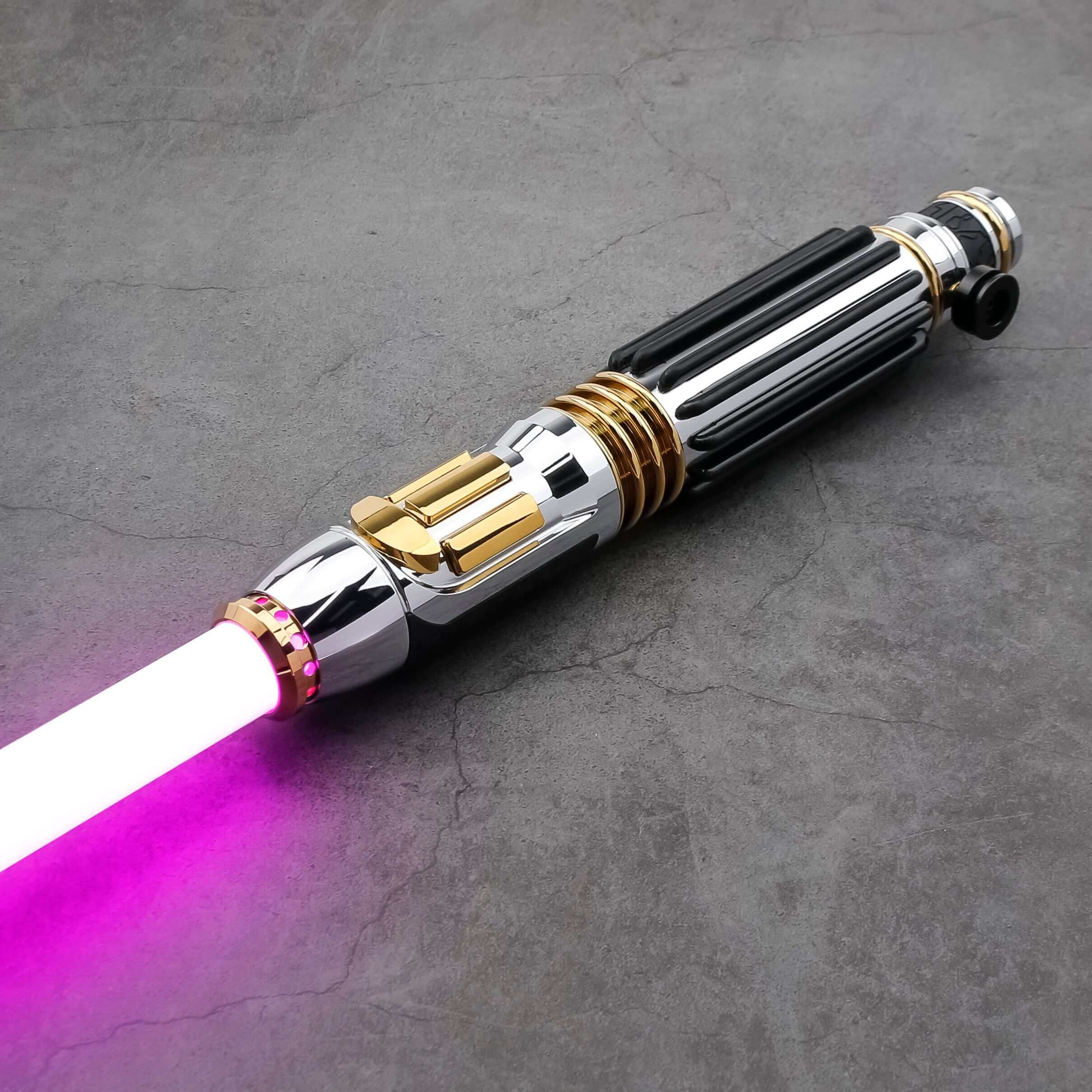 Windu Proffie lightsaber with chrome and gold accents and a glowing pink blade on a dark surface.