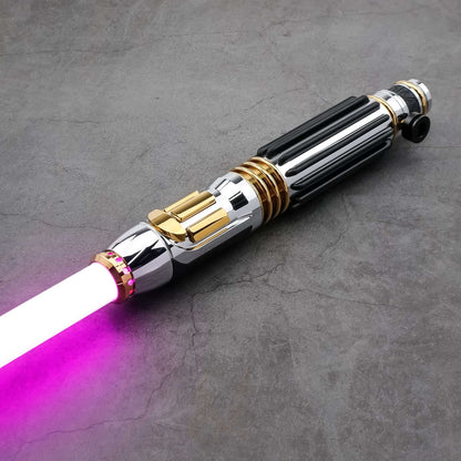 Windu Proffie lightsaber with chrome and gold accents and a glowing pink blade on a dark surface.