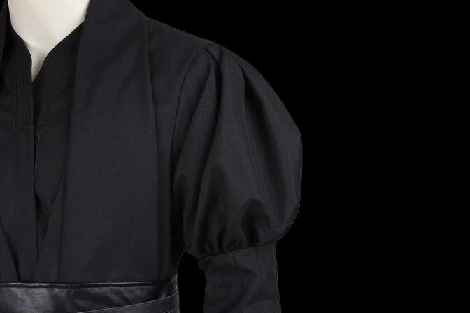 Close-up of the NovaSaber premium tactical enforcer suit showing dark fabric and structured design details.