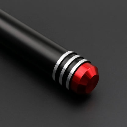Close-up of the Crimson Vortex lightsaber hilt showcasing its sleek black design and striking red accents.