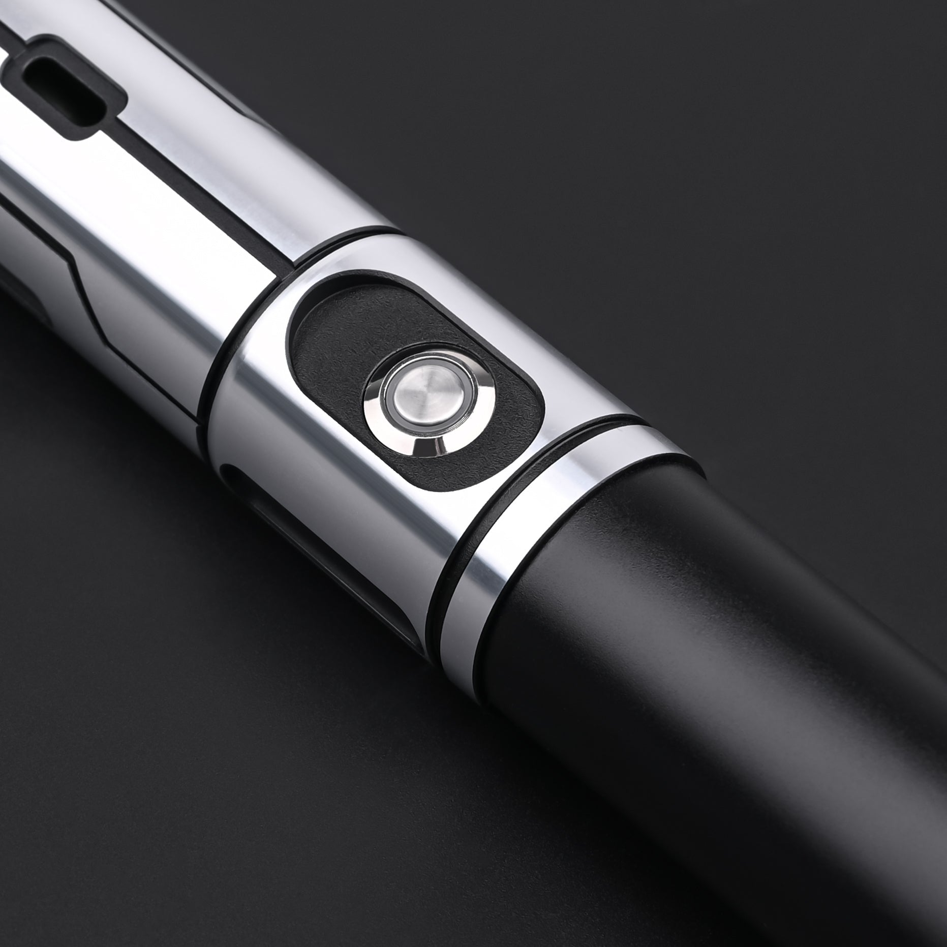 Detailed view of the Obsidian Elite Trinity lightsaber hilt control button and grip