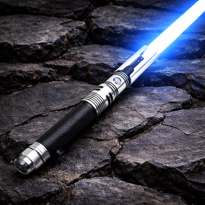 Fallen SE lightsaber resting on cracked rock background with bright blue blade and silver-black hilt