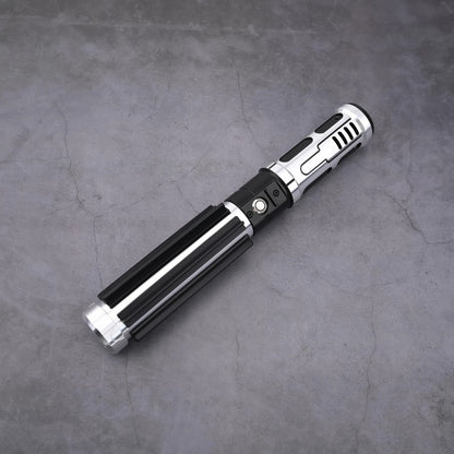 The Void Walker heavy dueling lightsaber with polished silver alloy and matte black finish on a concrete background.