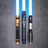 The Jedi Trinity lightsaber set standing upright with glowing blue blades