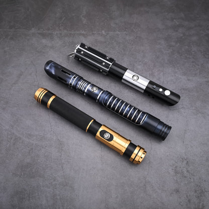 The Jedi Trinity lightsaber hilt bundle arranged on a textured surface