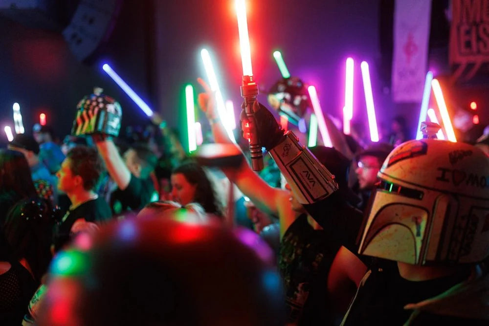 Customer holding NovaSaber lightsabers at a convention, showcasing durable and customizable gift options