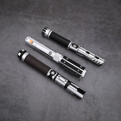 Overhead view of three Obsidian Elite Trinity lightsaber hilts without blade illumination