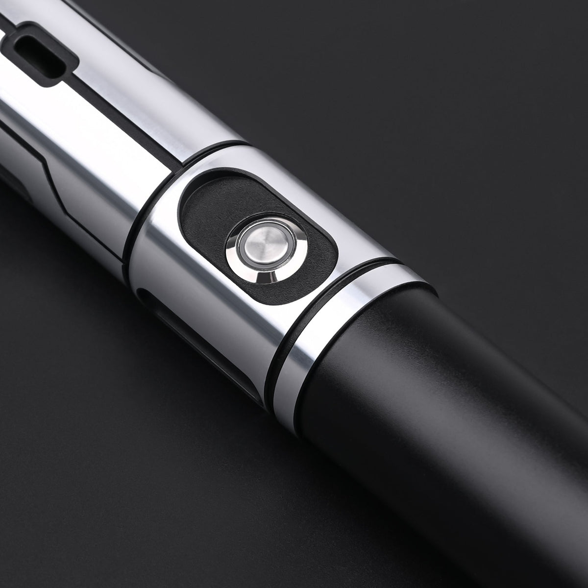 Detailed view of the Obsidian Elite Trinity lightsaber hilt control button and grip