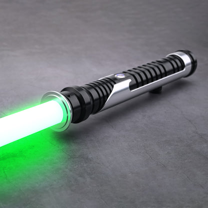 Close-up view of the Qui-Gon SE lightsaber hilt with active green blade illumination