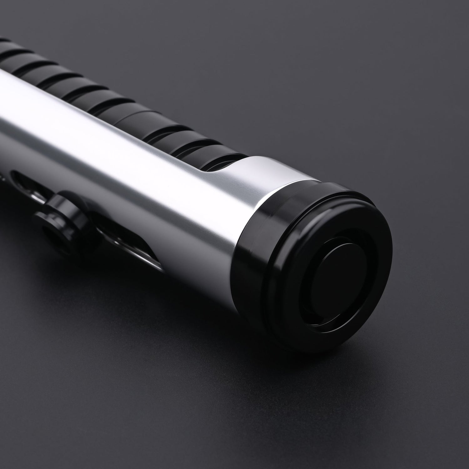 Close-up of the Qui-Gon SE lightsaber hilt pommel and bottom design details